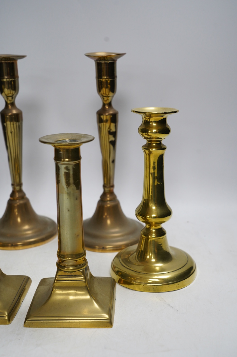 Three pairs of brass candlesticks, tallest 24cm. Condition - fair to good